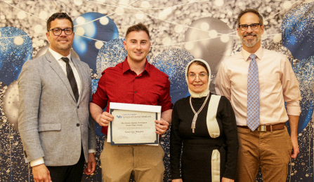 Tanner Wakefield holding award with Dean Araujo, Dr. Bairam and Dr. DeLuca. 