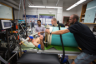 CRESE investigators at the University at Buffalo prepare a subject for a lower body negative pressure procedure to simulate blood loss. Photo: Douglas Levere