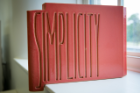 Each of the 120 terra cotta blocks that make up the new faculty mailboxes in Hayes Hall is etched with one of the 42 words that appeared, in sets of three, on the panels of the uppermost floor of the Frank Lloyd Wright-designed Larkin Administration Building in Buffalo. The building was demolished in 1950. This block reads "Simplicity." Photographer: Meredith Forrest Kulwicki