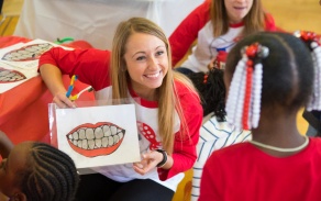 A student smiles during an outreach event. 