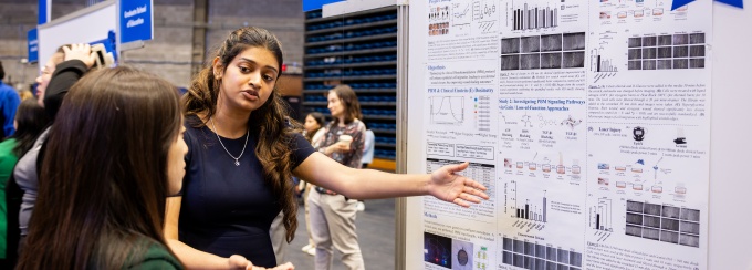 A student presenting a research poster.