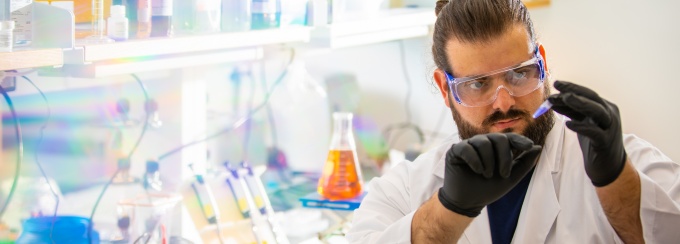 PhD student Petar Pajic, working in a research lab in Hochstetter Hall in July 2022. This research is part of a new study, where the team used a gel electrophoresis technique to separate mucins from other proteins in the saliva of various mammals.