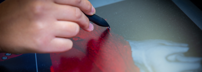 A hand drawing a research model. 