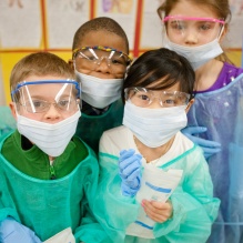 Children dressing up as dentists. 