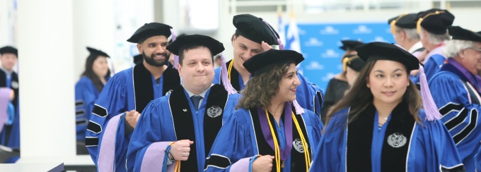 Graduates at the 2024 dental school commencement ceremony in graduation regalia. 