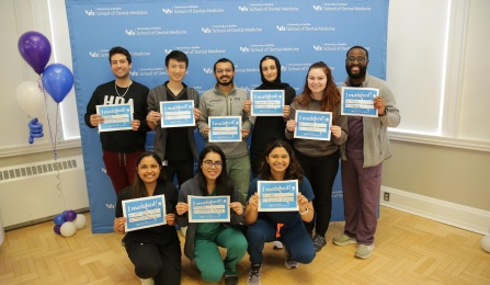 Dental students holding up Match Day signs for Match Day 2025. 