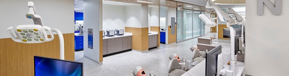 photo of preclinic simulation lab with benchtops, chairs, and computer screens. 