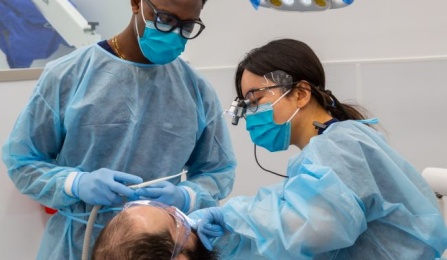 dental students working on a patient in the clinic. 