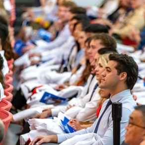 group of seated students at the White Coat ceremony. 