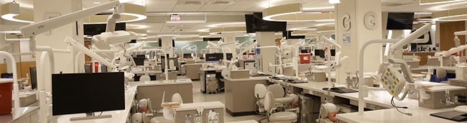 photo of preclinic simulation lab with benchtops, chairs, and computer screens. 
