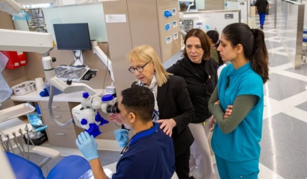Faculty teaching students about technology in the clinic area. 