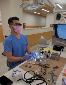 dental student working on benchtop in preclinic simulation lab. 