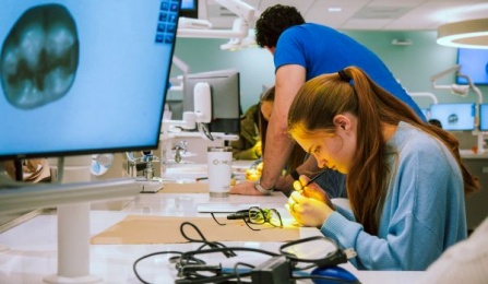 prospective student working in predental simulation lab with tools. 