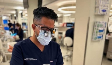 dental student working on mannequin in preclinic simulation lab. 