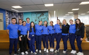 A group of students standing in the patient waiting area. 