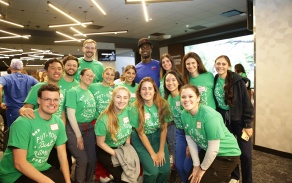 A group of students with a Buffalo Bills football player at a dental outreach event. 