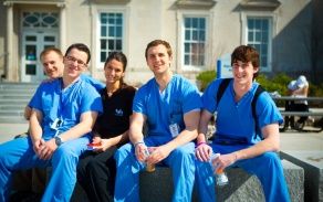 current dental students posing for a picture outside of Squire Hall. 