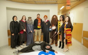 dental students dressed up in Harry Potter Costumes standing in front of a hallway. 