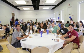 group of dental students sitting at a round table during DDS Orientation. 