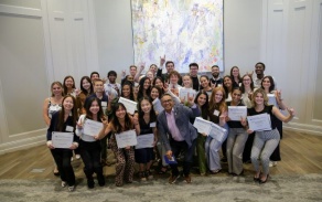 group photo of dental student scholarship winners in front of a large painting. 