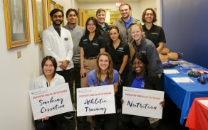 students pose with posters for the Dentistry Smiles on Veterans event 2023. 