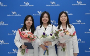 students pose with flowers during the White Coat Ceremony 2023. 