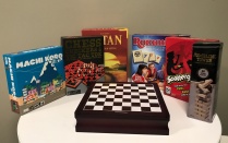 various unopened board games placed on a table. 