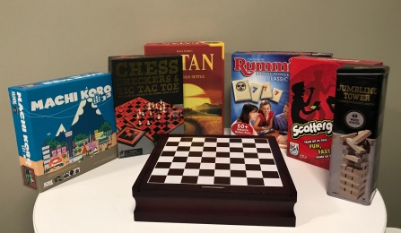 various unopened board games placed on a table. 