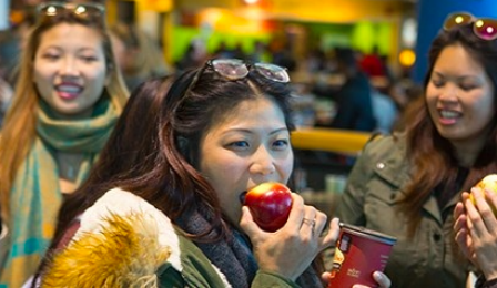 student enjoying an apple. 