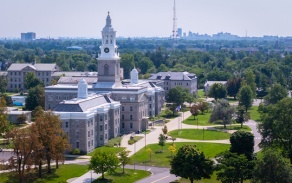 Picture of south campus from an aerial view showing one academic building with surrounding landscape during spring. 