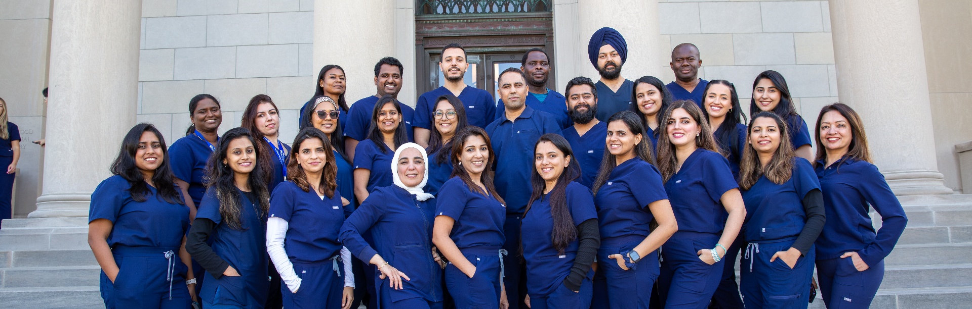 IDP students in scrubs on the steps of Abbott Library.