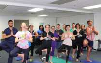 a group of students doing yoga. 