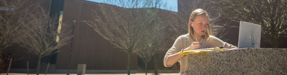 A student's laptop screen is open. 