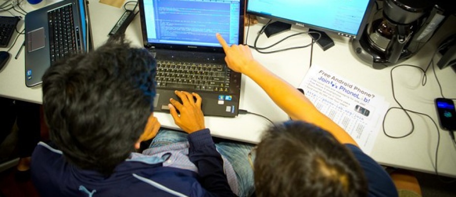 "two students looking at a computer". 