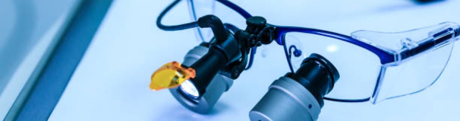 pair of dental loupes on tray.