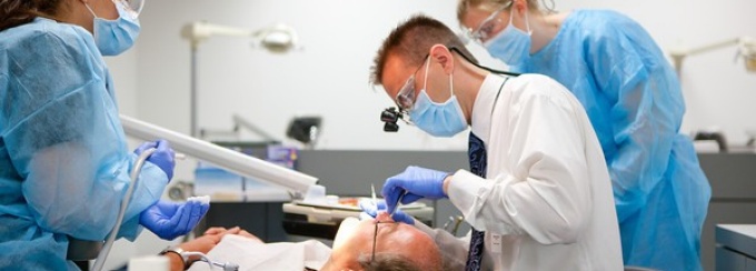 "dentists working on a patient". 