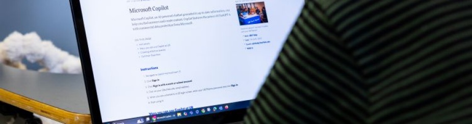 Evaluating AI generated work versus student work on notebook computer. 