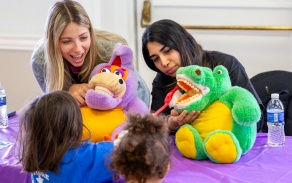 Students demonstrate brushing on a puppet at a recent outreach event. 
