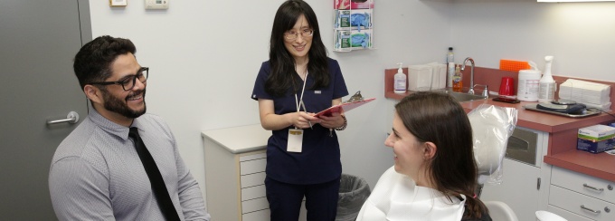 Two researchers and a patient in the Clinical Research Core facility. 