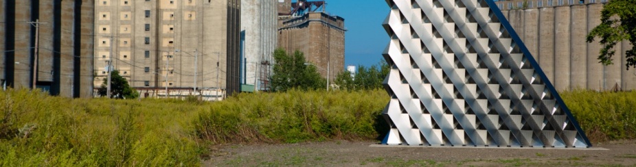 A large wall made from many pieces of interconnected, geometric steel. 