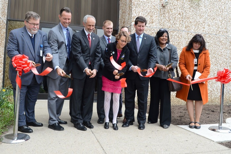 Michael Glick, DMD, third from the left cutting a ribbon for the ECHM.