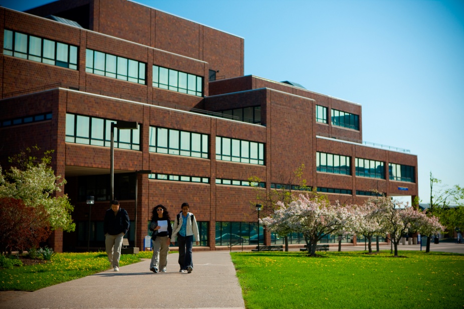 Students walking in front of the Jacobs Management Center. 