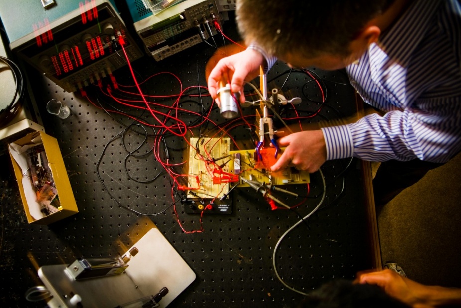 Albert Titus working at a workbench in his lab. 