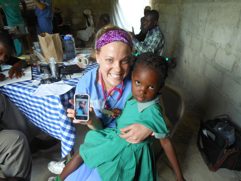 Ellen Tokarz with a patient at a Haiti clinic.