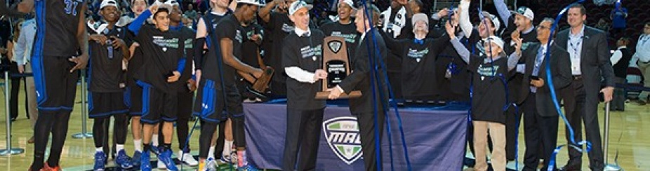 The UB men's basketball team and other celebrate the team's win on the Mid-American Conference tournament. 