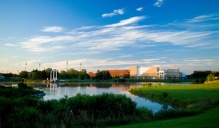 A lake in front of buildings on UB's campus. 
