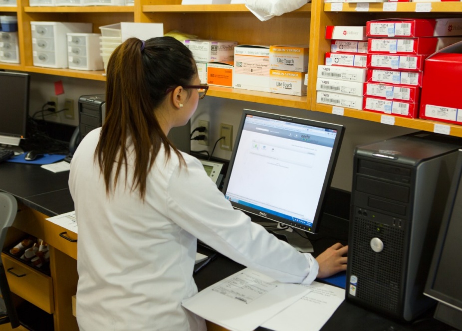 Pharmacy student using computer.