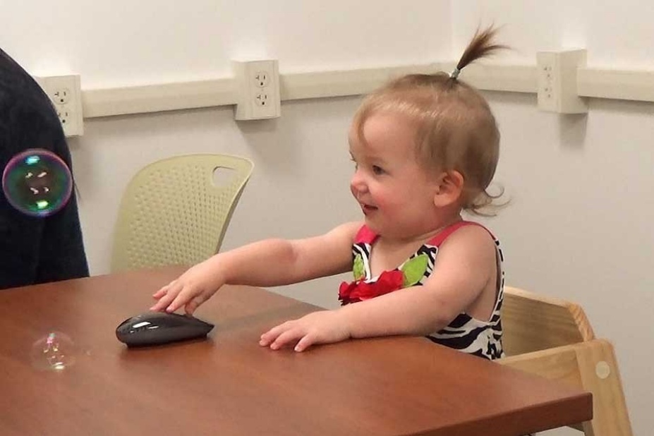 Infant responding positively to bubbles.