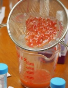 Zoom image: A strainer is used to filter pulp from strawberry juice. Photo: Bridget Brace-MacDonald 