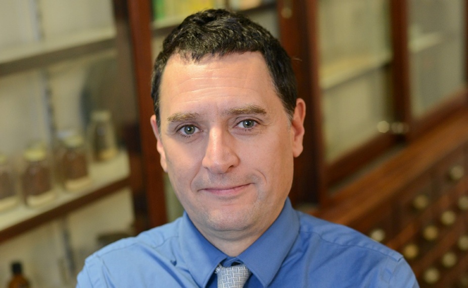 Javier Blanco standing in a pharmacy lab. 
